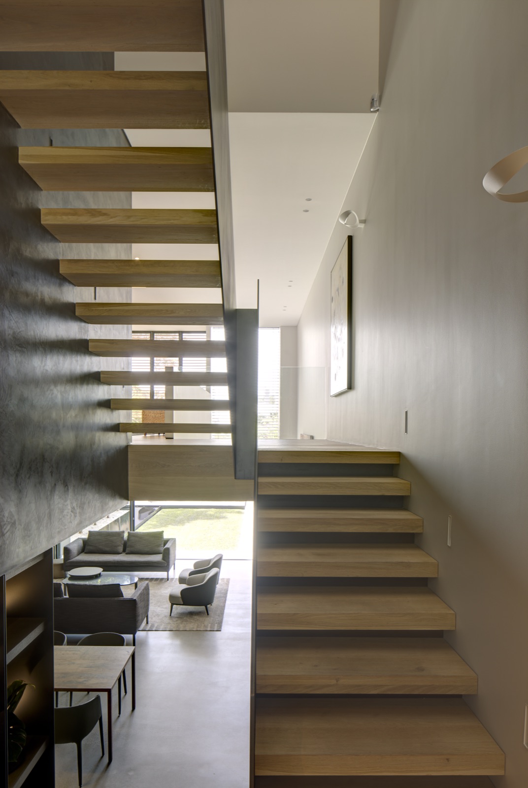 Suspended walnut stair with brass spine